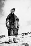 Smiling Inuit man wearing a fur parka and leggings [Bernard Iquugaqtuq from Pelly Bay. He probably came to Naujaat to trade his furs with the Hudson's Bay Company. This was a common practice throughout the 1930s to the 1960s as there was no store in Pelly Bay then.] 1951