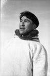 Inuit man in a white parka with a fur-trimmed hood [graphic material] 1951