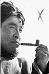Inuit man smoking a pipe [Iquugatuuq] [graphic material] 1951