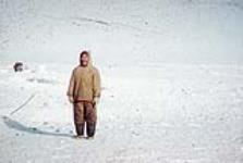 Inuit man wearing a sweater with a green and orange stripe [graphic material] 1953