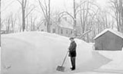 Stringer clearing snow February 1934.
