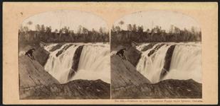 Man seated on cliff facing Chaudiere Falls, Quebec ca. 1865-1880