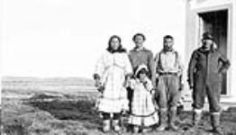 Group of Inuit (left to right): R. Kevolla, Kingucklack, Aigikak, Tom Goose. The child is unidentified Summer 1934
