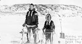 Constable A.J. Chartrand (left) and 12 year old Inuit interpreter Peter Natit holding nets with caught fish n.d.