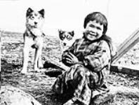 Inuk girl with husky pups 1931