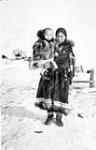 Inuk woman [identified as Mabel (Paodzena) Carter], holding her infant son [Sam Carter Jr.] ca 1910