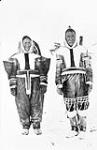 Close-up frontal view of an Inuit couple wearing traditional parkas from the Kugluktuk region 1930