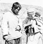 Inuit man, woman and child n.d.