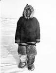 Inuk man in a duffle parka and caribou snow pants, Baffin Island (Qikiqtaaluk), Nunavut n.d.