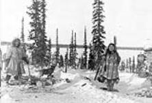 Nagosak and MaMayuk, daughter and wife of S/Cst. Ilavinek, chopping wood Winter 1915-1916