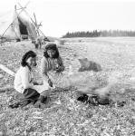 Inuit girls frying fish over an open fire on the Cape Hope Islands 1949