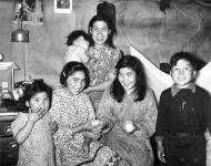 Inuk mother and her children holding oranges obtained through the Family Allowances program n.d.
