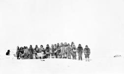Inuit of Cockburn Bay wearing caribou parkas in the snow May, 1926