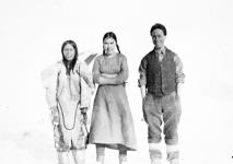 Inuit women, one wearing an amauti, and an Inuk man 1926