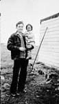 Unidentified Inuit baby being held by a white man [graphic material] ca. 1930-1943
