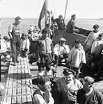 Group of Inuit trading with the crew of the "Regina Polaris" in Cape Dorset (Kinngait) 1948