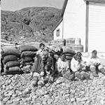 Group of Inuit waiting to get teeth extracted by Dr. Amyot in Cape Smith 1949
