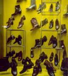 Store window display of racks of boots and shoes on Queen Street West 1976-1978.