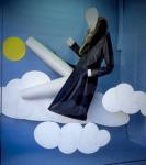 Store window display on Queen Street West. Display is of a coat, posed, against a background of a bright blue sky filled with sun and clouds (all constructed of construction paper) 1976-1978.