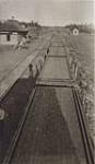 [Depot with flat rail cars] 1917.