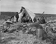Group of Inuit in front of a tent in Chesterfield Inlet (Igluligaarjuk), Nunavut 1948.