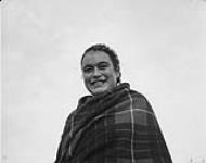 A smiling Inuit woman wearing a shawl in Kuujjuaq (formerly Fort Chimo), Quebec 1948.
