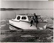 Fred Fraser mining recorder at Yellowknife with his cabin boat n.d.
