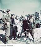 [Canadian soldiers, including Capt. M.A. Cardinal, from Régiment de la Chaudière with residents of Bernières-sur-Mer on June 6, 1944] [graphic material] ca. 1943-1965.