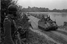 Field exercise - Two German soldiers guard approaches to floating pontoon bridge as 3 RCR cross during exercise - Photographer Sgt. Rodger September 1978.