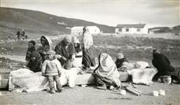 [Inuit men, women, and children covering a kayak] Original title: Covering kyak 30 July 1932.