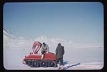 No. 5 - Red J-5 snowmobile and 2 men 1957-1958.