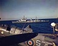 Cruiser HMCS UGANDA, with a Fairey Firefly on HMCS WARRIOR in the foreground [ca. 1945-1947]