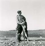 [Mountie and dog] [between 1928 and 1950].