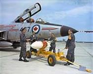 CFB Chatham, Inspecting missile prior to loading onto CF 101 Voodoo aircraft, Left to Right, Cpl. V. MacFadyen, Cpl. J.G. Adams, Cpl. R. Leblanc and Cpl. J.L. Mather 1968