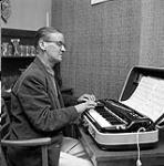 [Gordon Hollingsworth playing a portable piano, Iqaluit, Nunavut] [between 1956-1960]