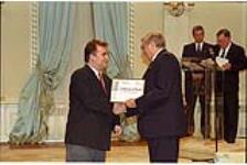 [Greg Urbanoski, representing The Daily Herald, accepts a Citation of Merit from Governor General Roméo LeBlanc on behalf of the newspaper] May 12, 1995.