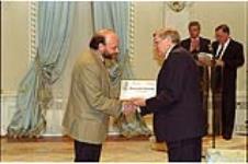 [Sylvain Blanchard, senior reporter for Le Devoir, accepts the Honourable Mention award from Governor General Roméo LeBlanc on behalf of his newspaper] May 12, 1995.