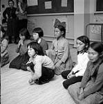 [Girls [l to r: unknown, unknown, Leah Ipeeleer, Rosie Noudlak, unknown, Rosie Salmonvalley, unknown] at a Brownies meeting, Iqaluit, Nunavut] 1960