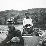 [Henry Anatuk [Angnatuk] and a group of boys [(Palia) Edward Snowball and Sanak Ungnatweenuk] in a boat, Killiniq, Nunavut] 1960