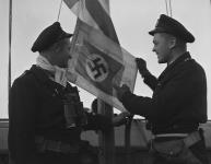 Capture of German Ship, Sub-Lieutenant James John Darling (right) with Lieutenant and German flag n.d.