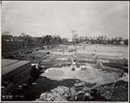 Looking north west toward Carling showing O-Train track and wartime Temporary building No. 5 under construction, October 9, 1941 October 9, 1941.