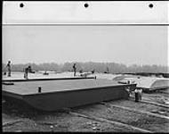100 ton barges under construction on ways at Brechtel-Price-Callahan, Fort McMurray Yard n.d.
