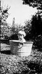 [Child seated in an aluminum tub] (copy) [between 1977-1988]