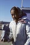 Elderly Inuit woman holding statue, Arviat [Margaret Atatluk Yaha] 1979.