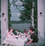 Man and woman lunching outdoors at Hovey Manor, Québec juillet 1950
