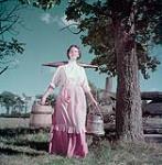 Woman dressed as a nineteenth century dairy farmer as represented in the NFB production on the Canadian dairy industry August 1950