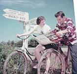 Man and woman on bicycles, Prince Edward Island National Park July 1953