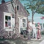 Two men and one woman outside a souvenir shop, Fundy National Park, New Brunswick July 1953
