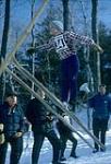 Eleven year old ski jumper Kim Frapp in mid-air. Midget Skiing (probably Camp Fortune) février 1964