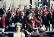 Her Majesty Queen Elizabeth II and H.R.H. Prince Philip riding in an open carriage during their royal tour, Ottawa 14 octobre 1957.